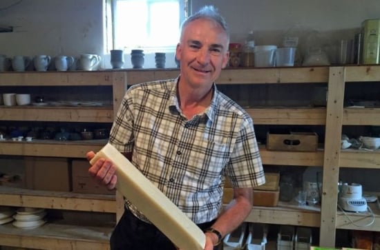 PEI craftsman Pieter Ijsselstein with an uncut bar of potato soap PEI craftsman Pieter Ijsselstein with an uncut bar of potato soap