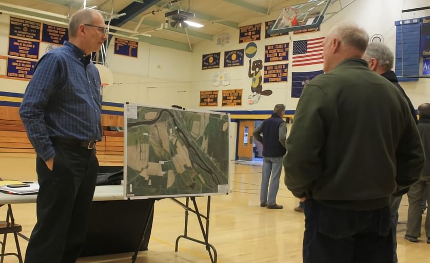 Jan Weigman, project manager at Wright-Pierce, left, talks about Penobscot McCrum's proposed potato processing plant in Washburn with attendees at an information meeting on April 23 at Washburn High School. (Courtesy: Anthony Brino | The Star-Herald)