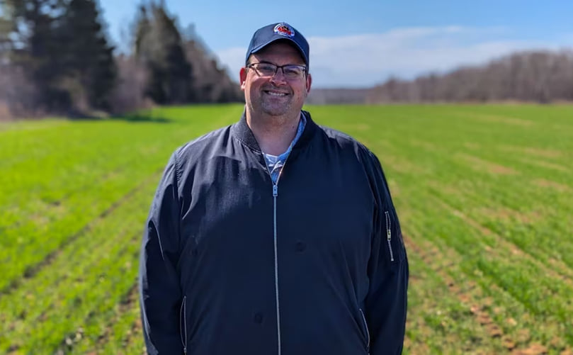 Potato Board researcher Ryan Barrett stands in a field of winter wheat planted last fall that will be harvested later this year as an extra cash crop. Courtesy: CBC Potato Board researcher Ryan Barrett stands in a field of winter wheat planted last fall that will be harvested later this year as an extra cash crop. Courtesy: CBC