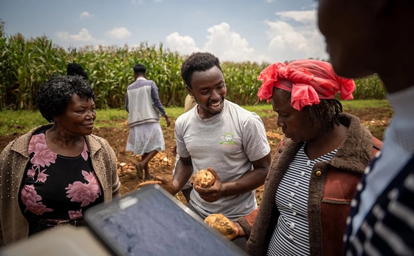 Potato farmer Peter Njuguna shares observations with fellow growers during the field evaluation in Njoro