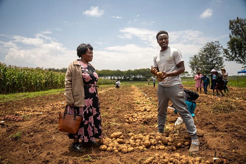 Potato farmer Peter Njuguna shares observations with fellow growers during the field evaluation in Njoro