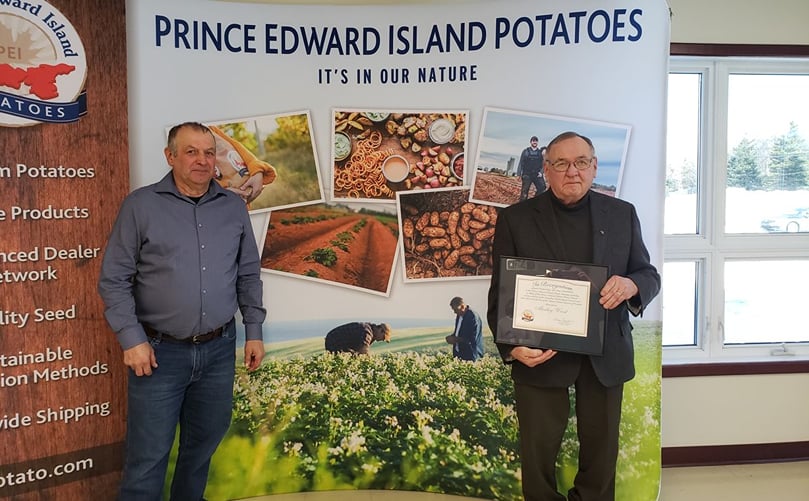 PEI Potato Board Director Donald Stavert (left) presents Potato Industry Recognition Award to Morley Wood (right) PEI Potato Board Director Donald Stavert (left) presents Potato Industry Recognition Award to Morley Wood (right)