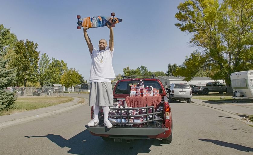 Nathan Apodaca's TikTok video, in which he longboards to his workplace to Fleetwood Mac's 'Dreams,' has catapulted him to viral fame. Here, he is standing in the pickup truck given to him by Ocean Spray. In his video, Apodaca sips from a bottle of Ocean S