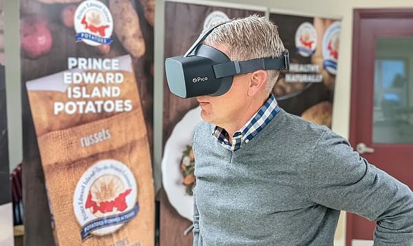 Potato Board general manager Greg Donald watches one of the videos while wearing the virtual reality goggles.