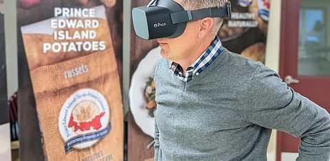 Potato Board general manager Greg Donald watches one of the videos while wearing the virtual reality goggles.