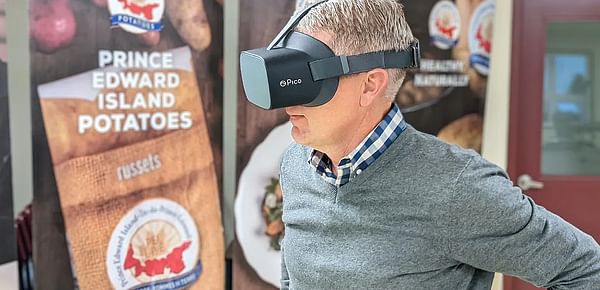 Potato Board general manager Greg Donald watches one of the videos while wearing the virtual reality goggles.