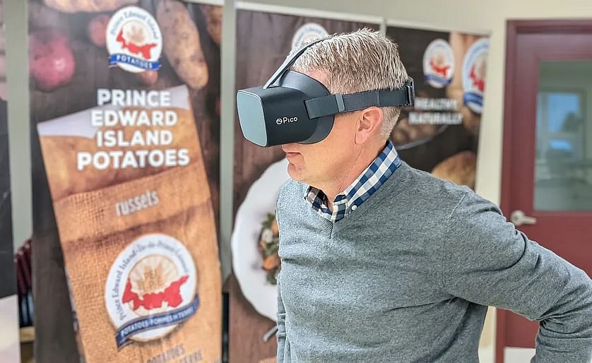 Potato Board general manager Greg Donald watches one of the videos while wearing the virtual reality goggles. (Courtesy CBC)