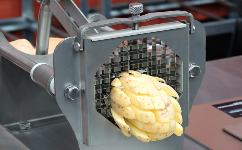 Precision Cutting of Potatoes into Uniform French Fry Strips in Industrial Processing Line Precision Cutting of Potatoes into Uniform French Fry Strips in Industrial Processing Line