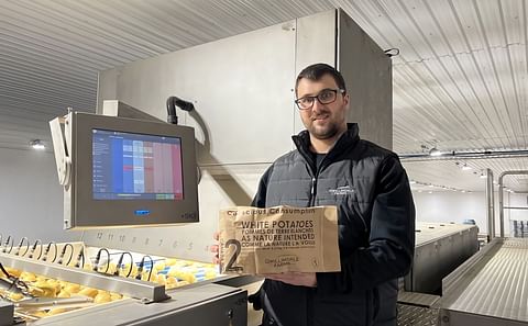 Quinton Woods, Senior Sales and Plant Operations Manager of Gwillimdale Farms holds a bag of the grower's new line, the Conscious Consumption™ line of potatoes.