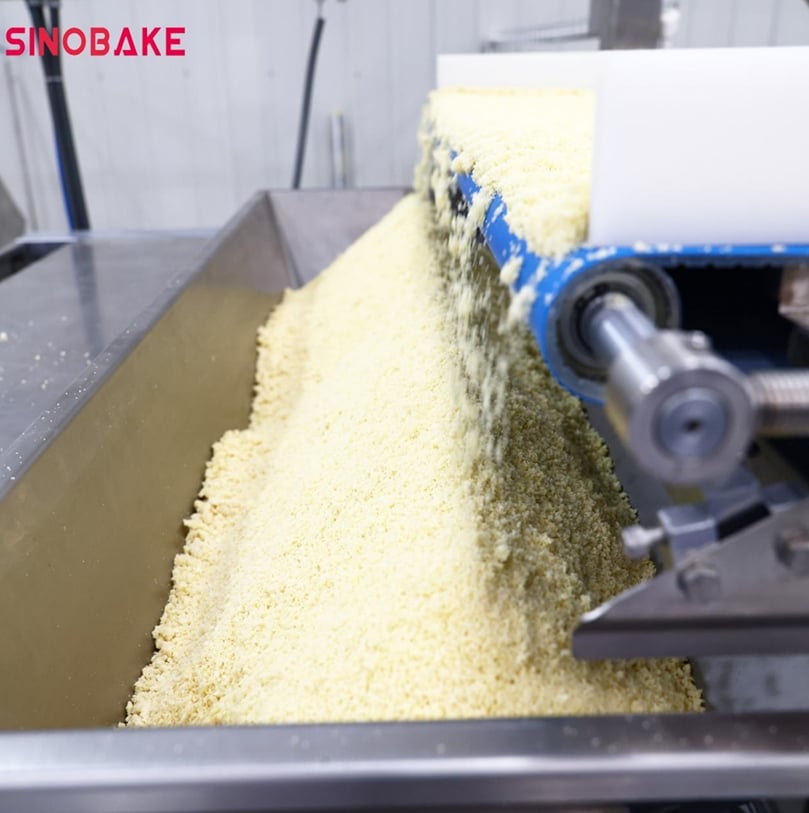 Raw potato mixture being processed on SINOBAKE’s automated production line, ensuring consistent texture and quality from the start.