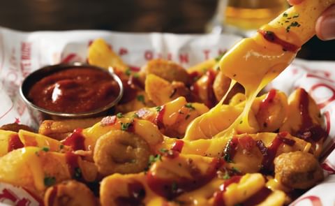 Available at Red Robin Gourmet Burgers and Brews restaurants for a limited time, Voodoo Fries features Red Robin's signature steak fries tossed in blackened seasoning, smothered in queso, topped with bacon, and fried jalapenos and drizzled with fiery ghos Available at Red Robin Gourmet Burgers and Brews restaurants for a limited time, Voodoo Fries features Red Robin's signature steak fries tossed in blackened seasoning, smothered in queso, topped with bacon, and fried jalapenos and drizzled with fiery ghos