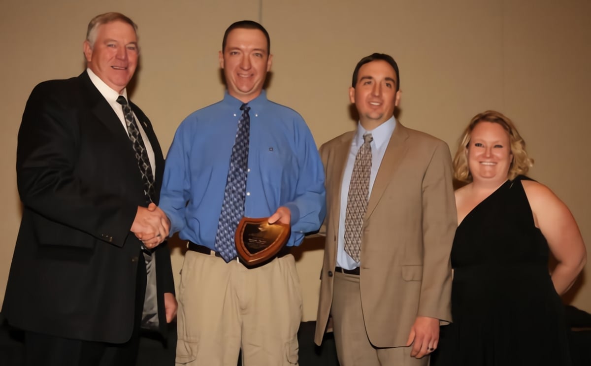 NPC 2014 President Randy Hardy hands the award to Brendon Rockey and Sheldon Rockey with wife Nicole. NPC 2014 President Randy Hardy hands the award to Brendon Rockey and Sheldon Rockey with wife Nicole.