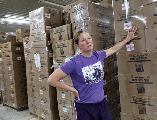 Jeanne Rue in the warehouse of their new facility, talking about the distribution of their Rue Farms Rustic Potato Chips to at least seven US States.