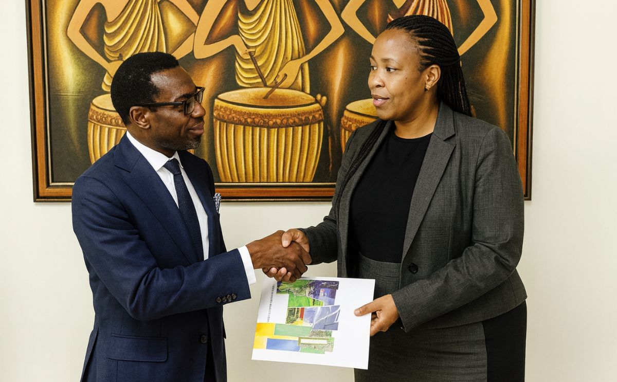 Olusegun Paul Andrew, the chairman of BlackPace Africa Group (left) and Clare Akamanzi, CEO of the Rwanda Development Board (right) exchange documents after signing the deal.
