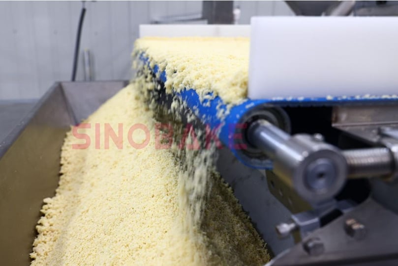Raw potato mixture being processed on SINOBAKE’s automated production line, ensuring consistent texture and quality from the start.
