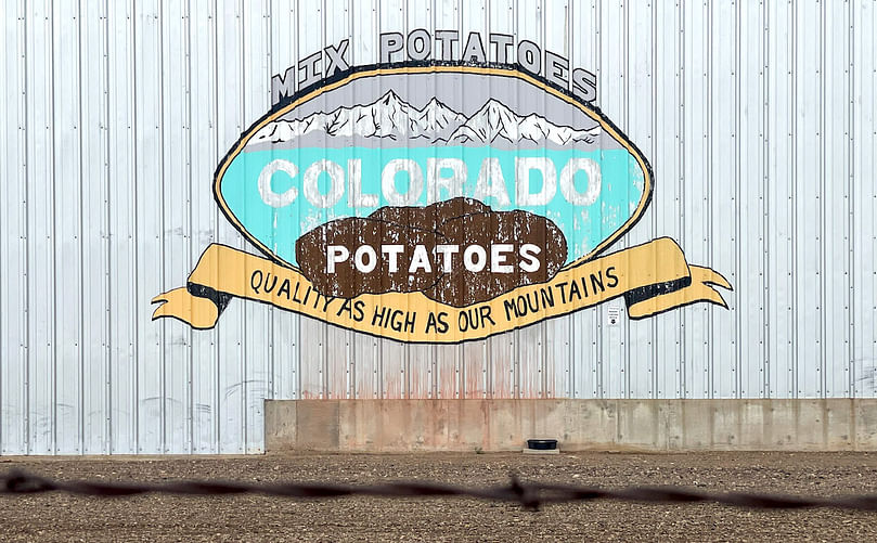 An advertisement for Colorado potatoes painted on the side of a shed in Center, Colo. on June 30, 2022.