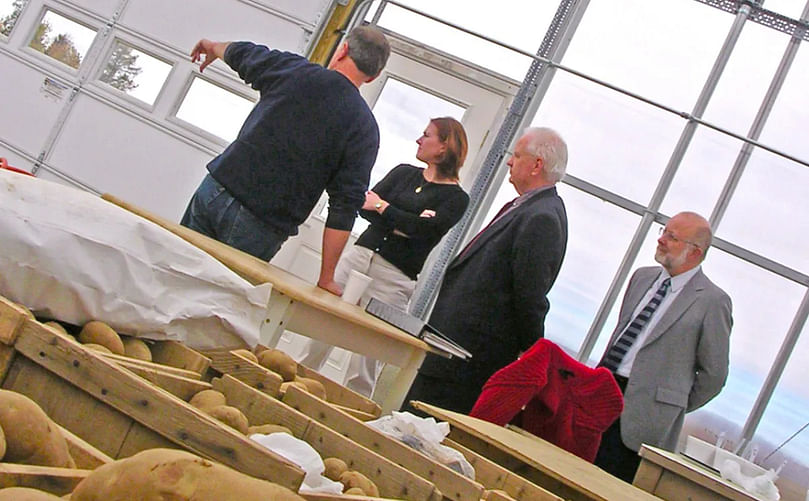 Steve Johnson (left), crop specialist with the University of Maine Cooperative Extension, gives a tour in 2004 of the greenhouse facility at the Aroostook Farm in Presque Isle. With him are UMaine representatives, from left, graduate student Erica Fitzpatrick, Interim Provost John Mahon and Michael Eckardt, vice president for research. (Courtesy: Rachel Rice / BDN)