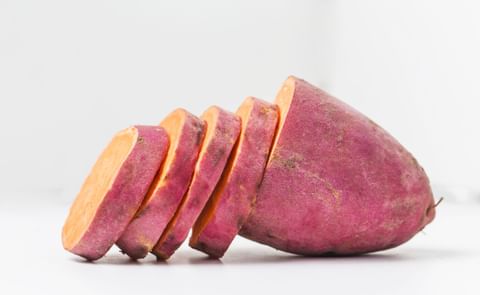 Raw sweet potato, partically cut Raw sweet potato, partically cut