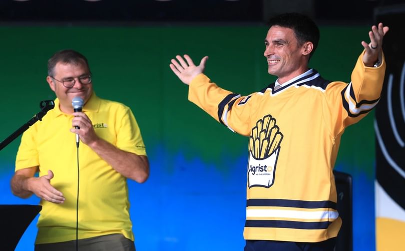 Grand Forks Mayor Brandon Bochenski models an Agristo jersey presented by Kristof Wallays, Agristo’s chief of global expansion, innovation and sustainability, during the “A Taste of Belgium” event at Town Square, celebrating the signing of a USD 450 million potato processing plant development agreement in Grand Forks.