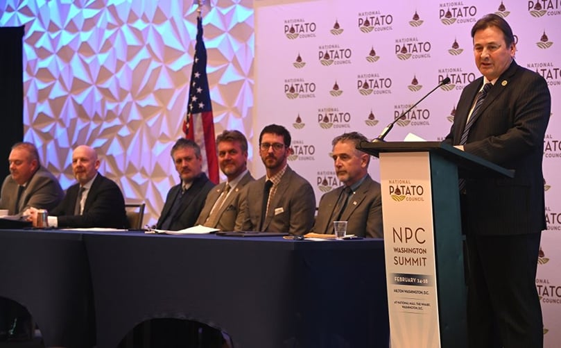 National Potato Council Ted Tschirky addresses the NPC Board of Directors at the 2025 Washington Summit. Executive Committee members joining him on stage include (from left to right): Brett Jensen, Chris Olsen, TJ Hall, Dean Gibson, Ben Sklarczyk, and Bob Mattive. (Courtesy: The National Potato Council). National Potato Council Ted Tschirky addresses the NPC Board of Directors at the 2025 Washington Summit. Executive Committee members joining him on stage include (from left to right): Brett Jensen, Chris Olsen, TJ Hall, Dean Gibson, Ben Sklarczyk, and Bob Mattive. (Courtesy: The National Potato Council).