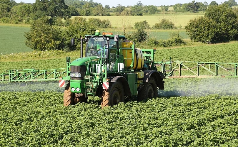 John Deere model in potato field John Deere model in potato field