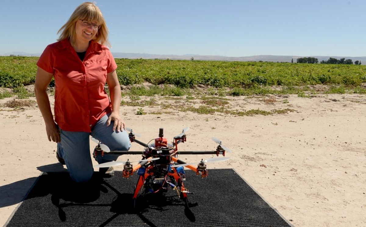Donna Delparte, assistant professor in the Department of Geosciences at Idaho State University with drone near a potato field. 
She presented her research results during the Idaho Potato Conference 2016.