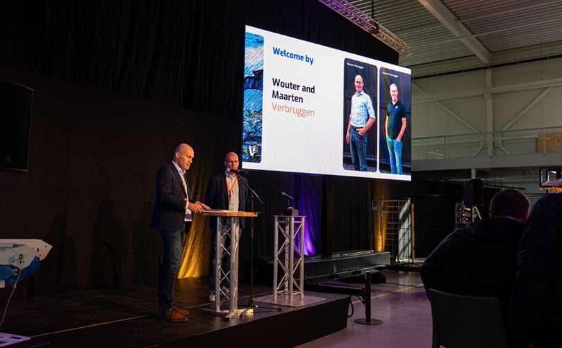 Wouter and Maarten Verbruggen, co-founders and executives of Verbruggen Palletizing Solutions, deliver the opening speech during the inauguration ceremony at the new headquarters in Emmeloord Wouter and Maarten Verbruggen, co-founders and executives of Verbruggen Palletizing Solutions, deliver the opening speech during the inauguration ceremony at the new headquarters in Emmeloord