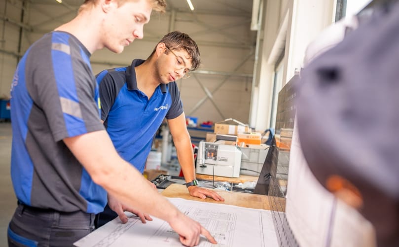 Engineering teams reviewing technical documentation during development of the next generation Verbruggen Topframe for high-speed end-of-line palletizing systems