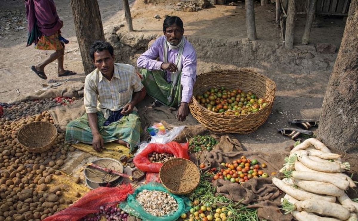 Tribal villagers bargain for vegetables on January 14, 2009. Kumrokhali, West Bengal, India.