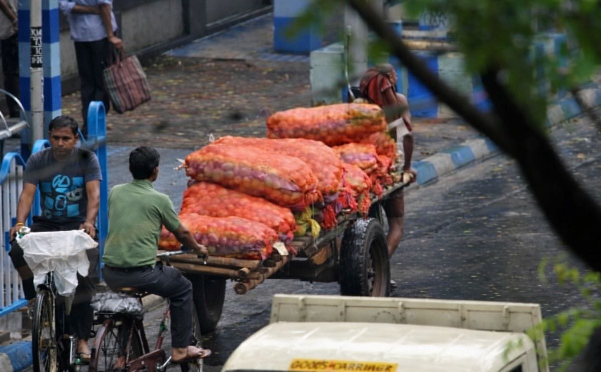 A worker is seen transporting potatoes to a local market after a spell of rain in Kolkata on Wednesday (Courtesy: Ashoke Chakrabarty) A worker is seen transporting potatoes to a local market after a spell of rain in Kolkata on Wednesday (Courtesy: Ashoke Chakrabarty)