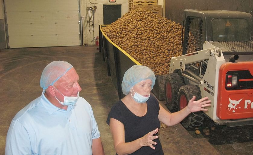 From left, Mister Bee sales director Rob Graham and owner Mary Anne Ketelsen describe how chips are made at the potato hopper at Mister Bee during a press event (Courtesy: Jess Mancini).
