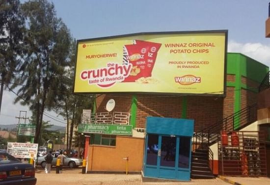 Billboard promoting Holland Fair Foods potato chips brand: Winnaz original potato chips and highlighting the fact that the chips are "locally" produced in Rwanda.