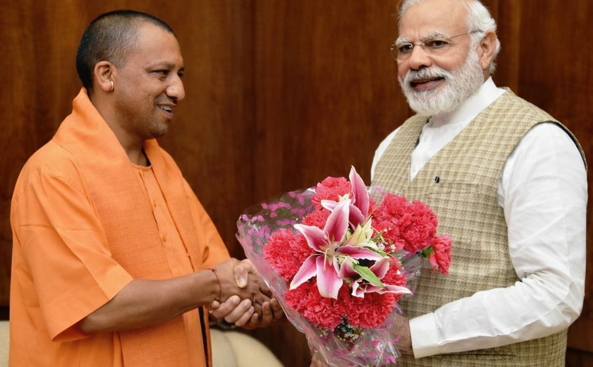 India's Prime Minister Narendra Modi (right) congratulates Uttar Pradesh Chief Minister Yogi Adityanath (left)