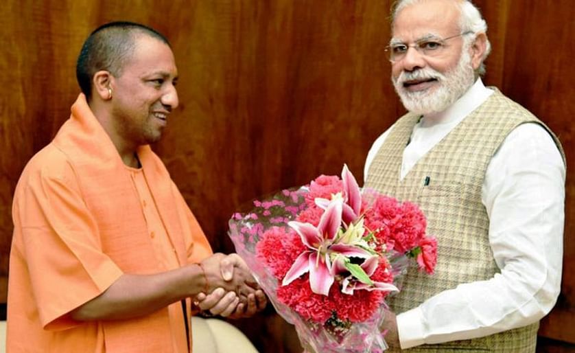 India's Prime Minister Narendra Modi (right) congratulates Uttar Pradesh Chief Minister Yogi Adityanath (left)